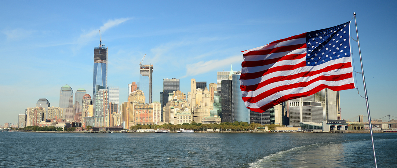 Flag of the United States with New York City in the background